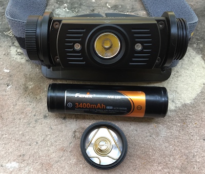 Fenix HL60R headlamp battery compartment with replaceable 18650 batteries.