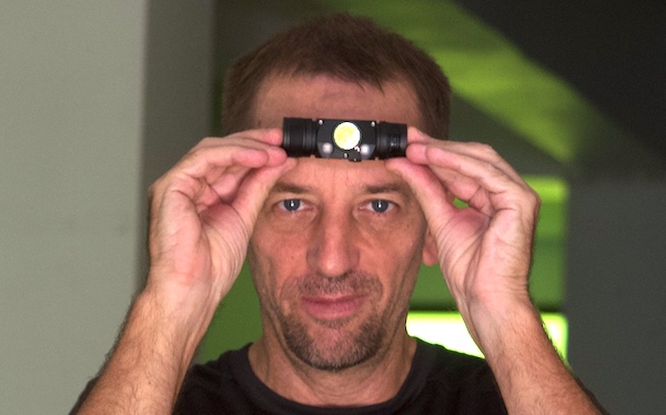 ACEBEAM H30 headlamp on forehead to show scale/size.