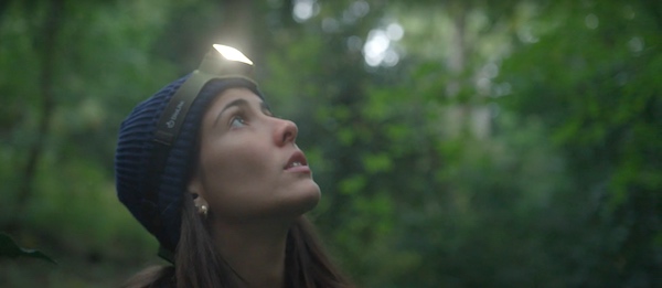 BioLite 750 headlamp worn by woman in the forest.